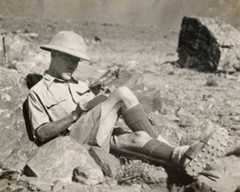 Colonel Guy Hamilton Russell filling in his game book while on a hunting expedition, 1930