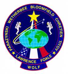 STS-86 crew patch. The flags for the three nations represented on the flight are incorporated in the design and the names of the astronauts ring the patch.