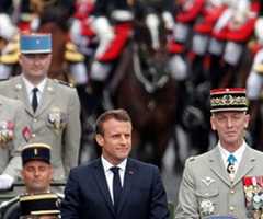 French President Emmanuel Macron heads a military parade on Bastille Day in 2018