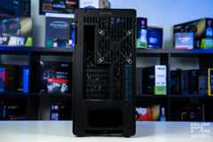 The rear of the HAVN BF 360 Flow standing on a white table and a blurred bookshelf of PC component boxes in the background.