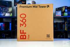 The brown box of the HAVN BF 360 Flow. It has a Premium Mid Tower at the top, BF 360 Flow in red sideways on the left, anda QR code and URL in the bottom right. It stands on a white table and a background of PC components boxes on a bookshelf.