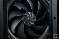 A black 180mm fan at the fron of the HAVN BF 360 Flow case, it has a spiral logo in the midal with a ridged hub towards the fins theat curve out and with slits at the edge.