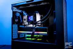 The inside of the HAVN BF 360 Flow case featuring a GPU, motherboard, AIO, and back fan. The background is a blue wall.