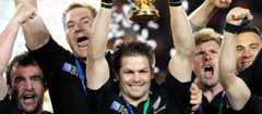 All Black captain Richie McCaw (centre) with the Webb Ellis Cup, 2011