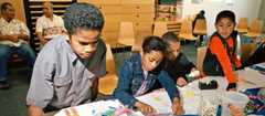 Fijian children drawing pictures of Fiji at Te Papa, 2002