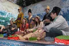 Nowruz entry in Intangible Heritage List young people in traditional dress sitting down on stage