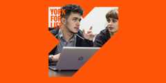two students working on a laptop as part of a York for Life branded image