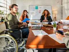 Office employees sitting together in a conference room. Office employees sitting together in a conference room.