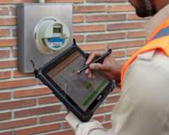 ET8x App Field Ops Tablets Gas Meter 5x4 3600 Professional meter reader uses Zebra ET8x Windows tablet to read and record a gas meter