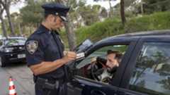 Police officer checking a driver's ID using a Zebra tablet Police officer checking a driver's ID using a Zebra tablet