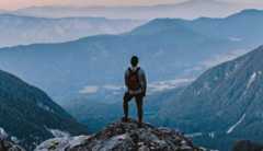 Hiker gazing at the view from a mountain cliff